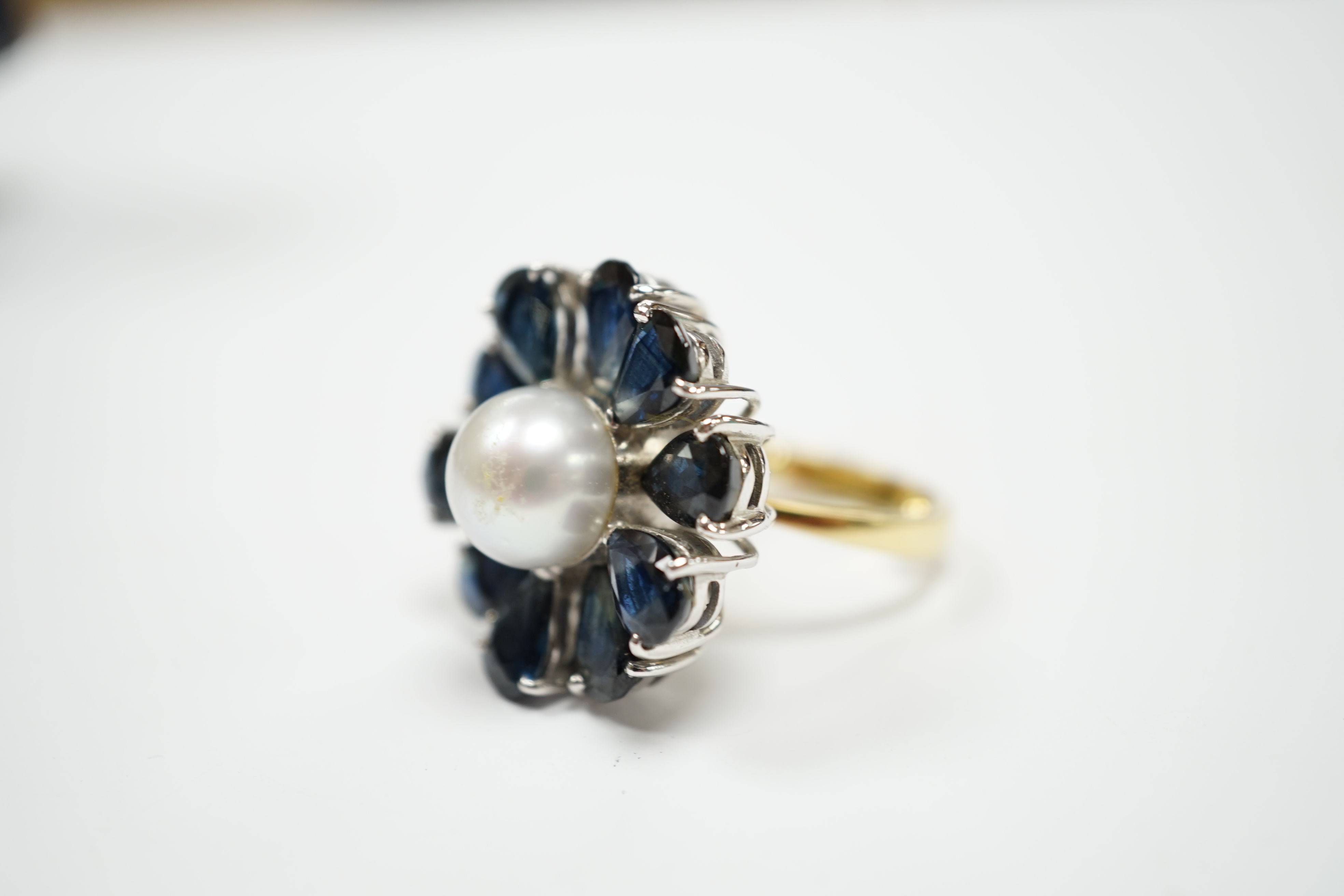 A modern large 18ct gold, single stone cultured pearl and ten stone pear cut sapphire set flower head cluster ring, size G, gross weight 15.4 grams.